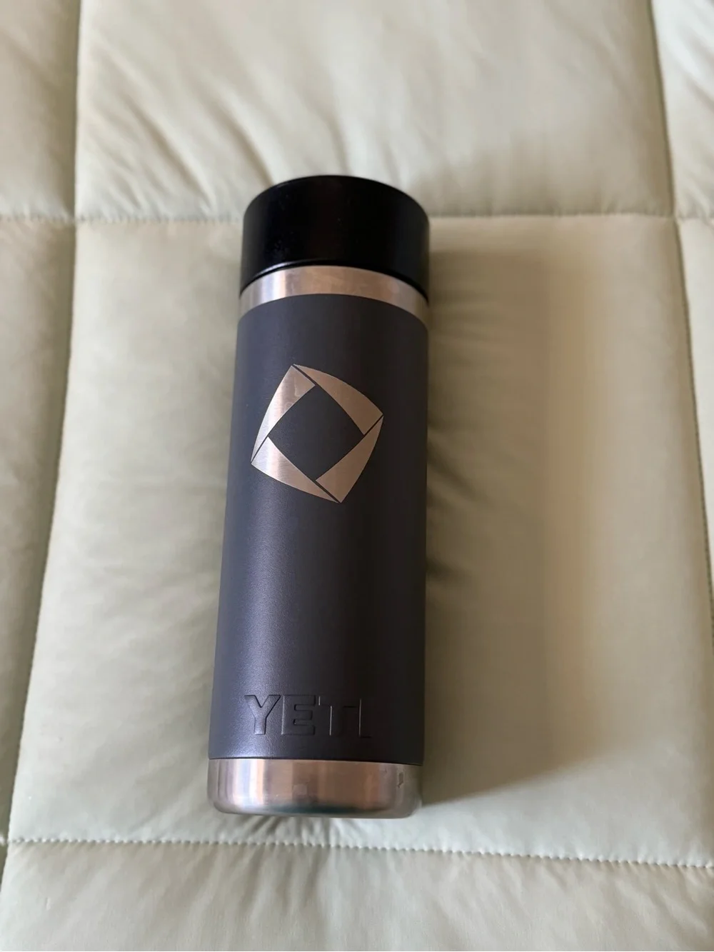 YETI Black and Silver Travel Bottle/ Rambler 18 oz Bottle in a charcoal